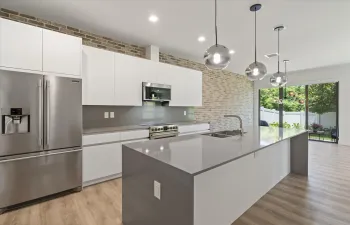 Modern Kitchen with Quartz Countertops and Waterfall Edges