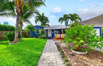 Charming entry path framed by lush greenery, with fresh thyme greeting you open arrival!
