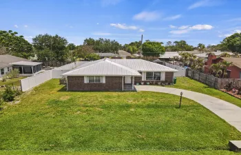 Brick beauty with timeless charm! Featuring a 2021metal roof, open-concept living, and an expansive private fenced backyard perfect for entertaining, pets, boats, RVs, and all your toys. NO HOA means freedom and flexibility in a home designed for comfortable Florida living!