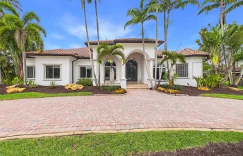 Mediterranean-style architecture, sprawling circle drive-way, plus expansive side drive-way to 3 car garage