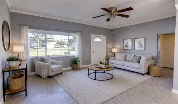 This photo has been virtually staged. Bright and airy living room design in Lake Park.