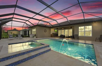 Heated pool and 6 person spa, with travertine tiles surrounding the screened area. Summer kitchen is a plus for outdoor entertaining