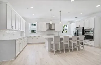 Extended Kitchen with Ample White Shaker Kitchen Cabinetry, Large Quarts 3