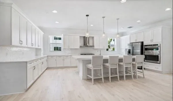 Extended Kitchen with Ample White Shaker Kitchen Cabinetry, Large Quarts 3