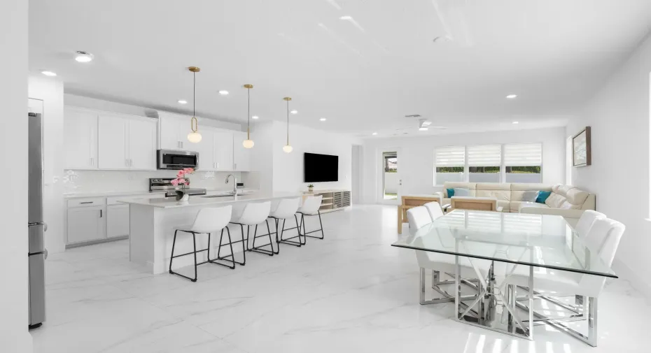 Step into a beautifully updated Living Room, Dining Room and Living Room complete with Modern Lighting and Dual Roller Shades and Porcelain Tile Throughout the First Floor. No Carpet in the home.
