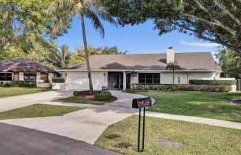 Tranquil front yard, lush landscaping and mature trees