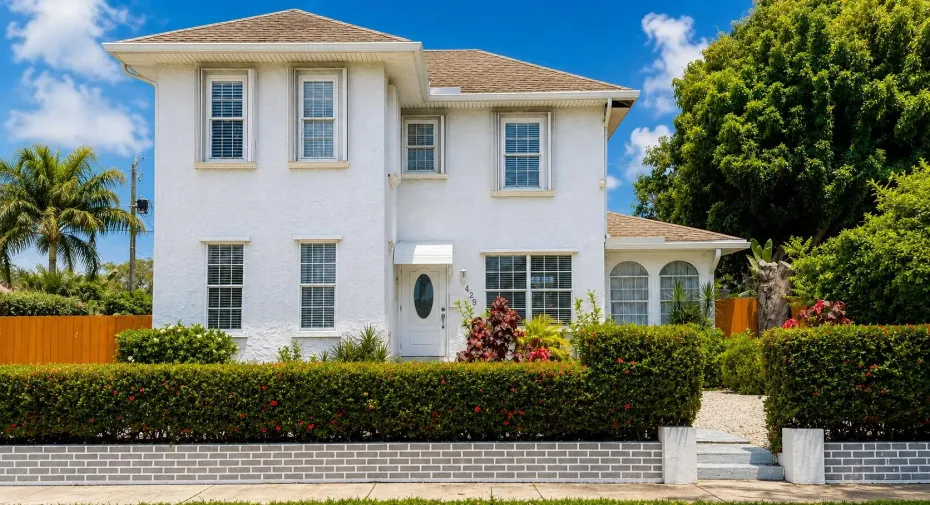 Charming 1922 historic two-story home located on one of the most desirable streets in Lake Park. This classic Florida home features a white stucco exterior, large light-filled windows, mature landscaping, and timeless curb appeal. Surrounded by lush greenery and tropical foliage, the property offers privacy, character, and a welcoming front entry. The spacious backyard includes mango and key lime trees, room for entertaining, boat or RV parking, and a detached garage with future potential. Walking distance to Park Avenue restaurants, shops, Town Hall, library, and nearby Kelsey Park. More photos coming soon!