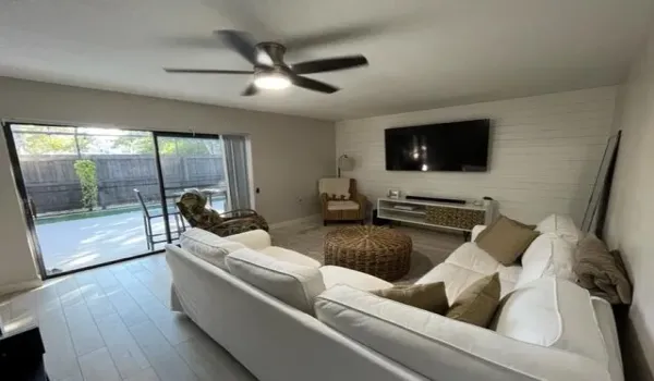 living room w/ shiplap accent wall and tile flooring.