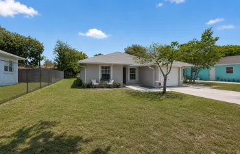Lovely property featuring an oversized driveway, mature trees, and inviting curb appeal