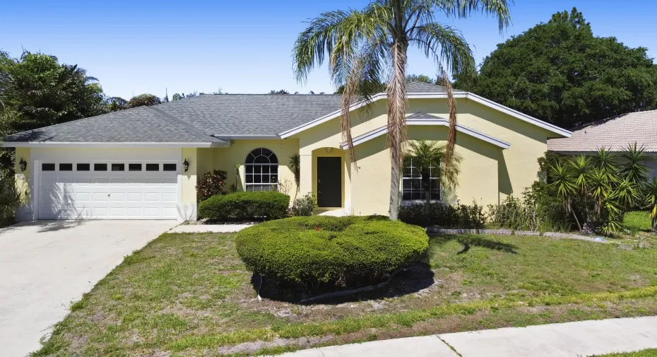 Beautiful curb appeal with tropical landscaping, soaring rooflines, and a spacious driveway welcome you to this charming 4-bedroom home in the desirable Saratoga Pines community of Royal Palm Beach.