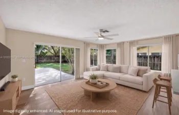 Bright family room space facing backyard for you to hang out in connected to kitchen. With Solar Shades. Virtual staging.