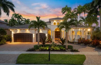 Front Elevation with Lush Tropical Landscaping, Custom Lighting and Circular Driveway