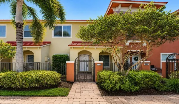 Tropical landscaping & charrming curb appeal welcome you home.