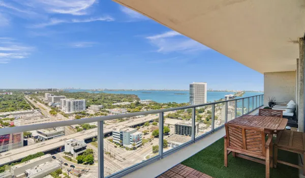 Breathtaking panoramic water and city views from the wrap-around private balcony take center stage in this stunning high-rise residence.