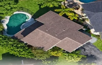 Expansive Backyard Oasis with patio and fenced pool.