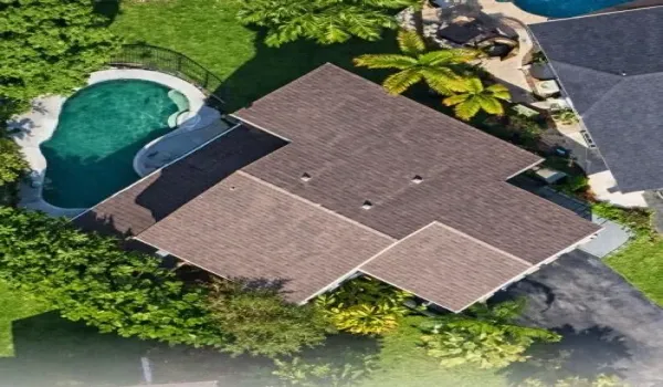 Expansive Backyard Oasis with patio and fenced pool.