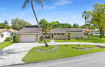 Front of house and lawn with huge half circle paver driveway