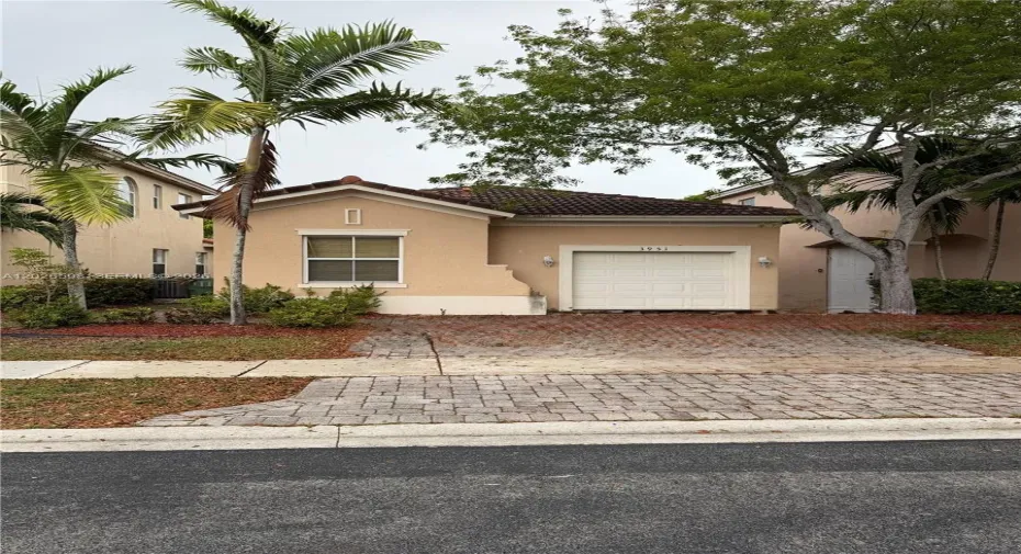 This photo shows the 1-car garage and 2-car front driveway.