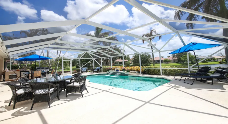 Pool, waterfall, huge deck area, summer kitchen & a full lake view beyond the rear of pool.
