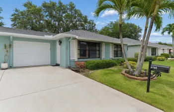Lovely 2Br/2BA tiled villa with garage and NEW ROOF 2026. Vacant for quick close. Great elevation