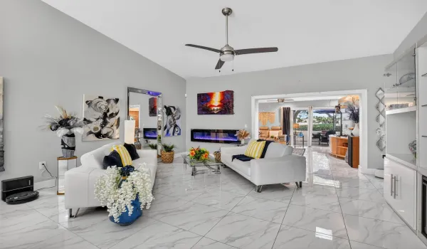 WOW, gorgeous porcelain tile! Living room with soaring 12' ceiling provides tons of natural light!