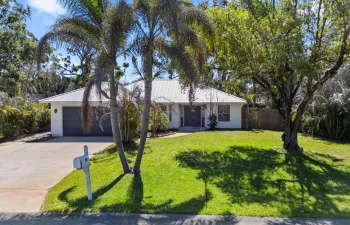 Front of the house showing charcoal blue garage and double entry door
