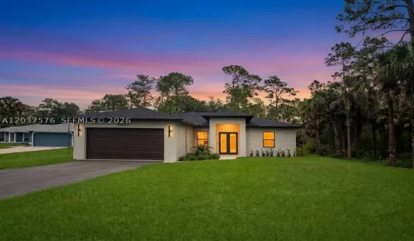 Contemporary stucco exterior with a dark shingle roof