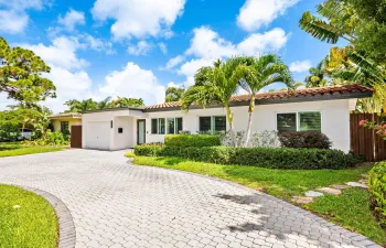 Front exterior with circular paver driveway.