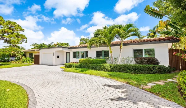 Front exterior with circular paver driveway.