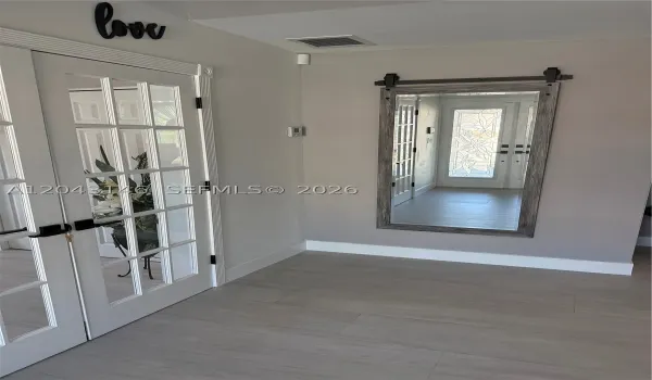 The entrance foyer with recreational room to the left.