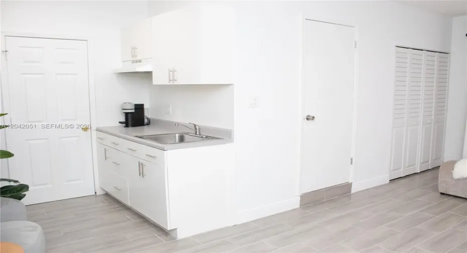 The 2-Car Garage was converted into a Studio/Home Office with a door that leads to the Laundry Area of the home, and a second door that leads to the an exterior entrance. There is a closet as well as a full bath and a wet bar. It is currently used as a Photography Studio.
