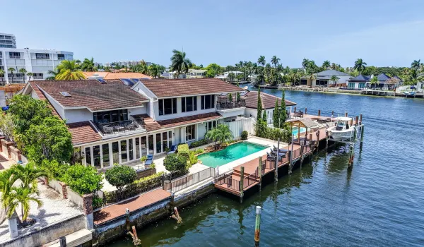 This aerial view shows the home’s rear elevation, pool, dock, and direct relationship to the canal. 90 Ft. Dockage
