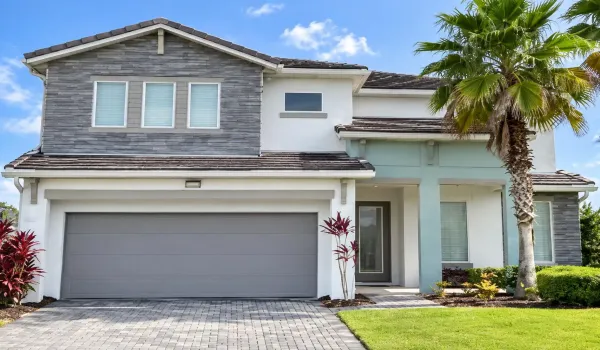Welcome to 3870 Oakville Avenue—a fully furnished, 5-bedroom, 5-bath resort home with an inviting two-story façade, paver driveway, and tropical landscaping in gated Sonoma Resort.