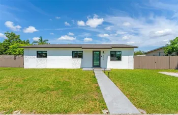 Modern curb appeal with fresh exterior paint, updated windows, and a spacious front yard.