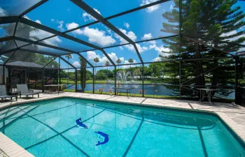 Enjoy sparkling water views from this beautifully screened pool patio with breathtaking lakefront scenery.