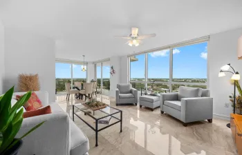 Bright, open living and dining areas feature marble flooring, floor-to-ceiling glass, and sliding doors that extend the space to the covered wraparound terrace with New River, downtown, and city views.