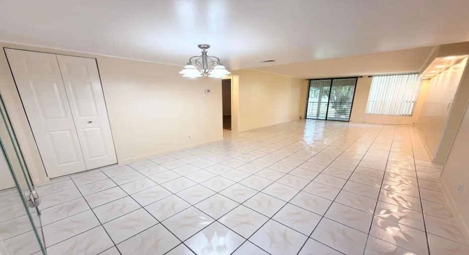 Spacious living/dining room with lots of light and natural sunlight. Plus access to balcony overlooking golf/lake/pool.
