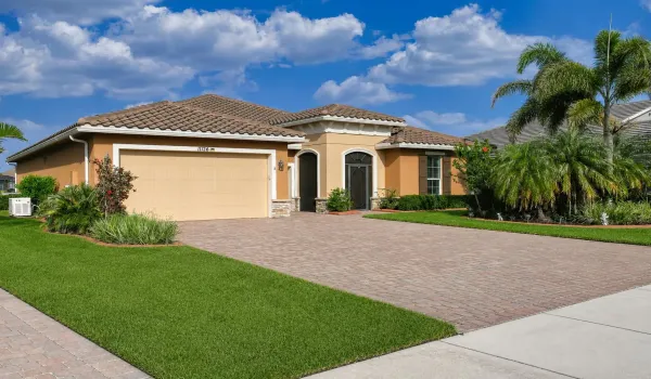 Elegant Mediterranean-Style Exterior with Beautifully Landscaped Front Yard