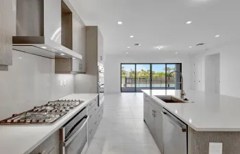 Gourmet kitchen featuring a gas range, stainless steel appliances, and a large center island with an undermount sink