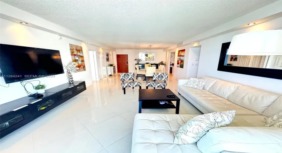 white leather sect sofa, Large Flat TV, upscale furnished
