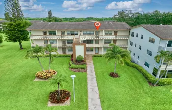 Three-story multi-unit building featuring balconies on each level
