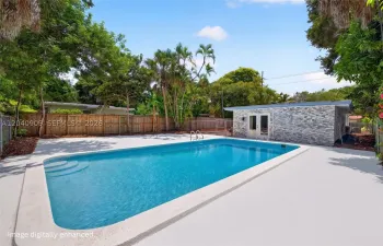 Pool area, deck cleaned via AI but the plants are all real! Image digitally enhanced. AI used for staging purposes