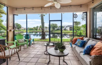 Screened patio with tile flooring and a ceiling fan