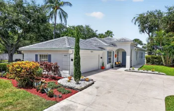 Stucco exterior residence with a tiled roof and blue window shutters