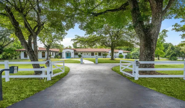 Beautifully updated residence featuring a newer terracotta tile roof, white stucco exterior, and a inviting entryway