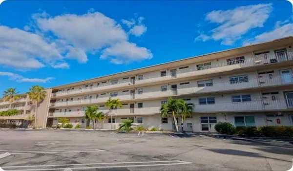 Multi-story residential building with private balconies and exterior walkways