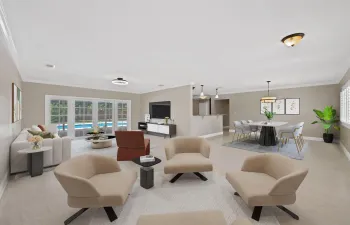 Expansive open-concept living space with light wood-finish flooring, crown molding, and recessed lighting