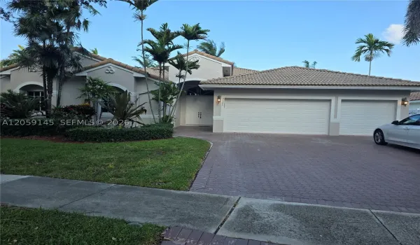 Front view of home and  three car garage