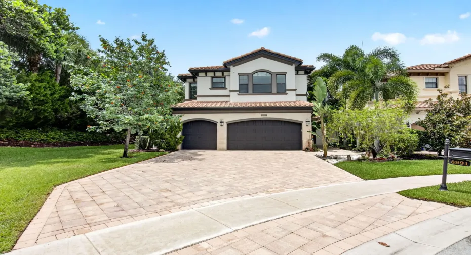Spanish-inspired two-story residence featuring a tile roof and stucco facade