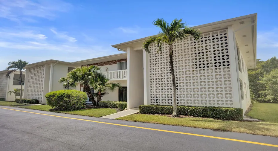 Mid-century modern building featuring decorative concrete block screen walls, white exterior finish, and a flat roofline